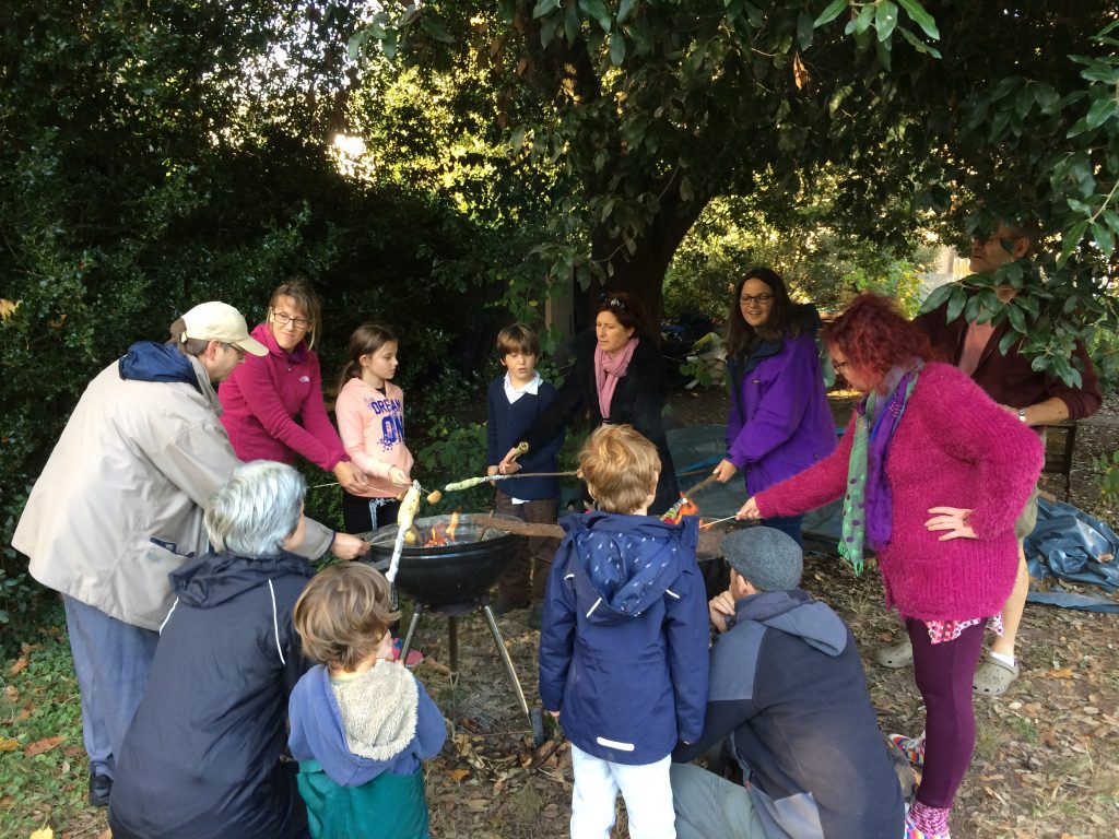 People cooking in community garden