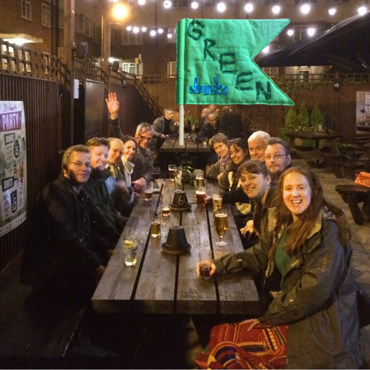 People around a table enjoying Green Drinks