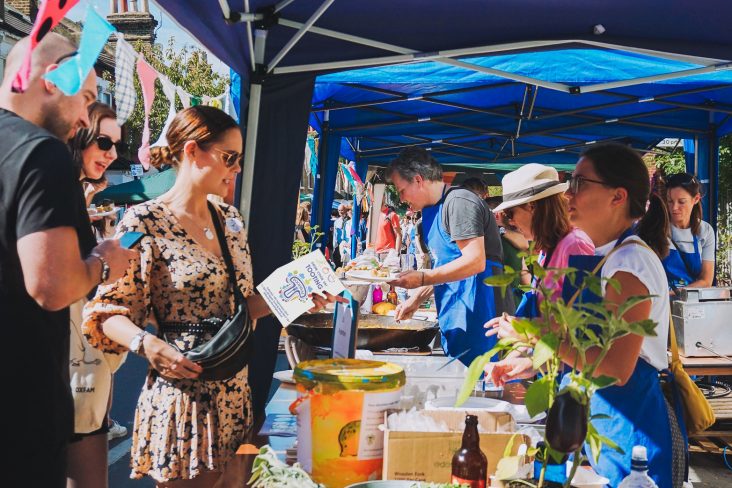 People engaged at Foodival stall in Tooting